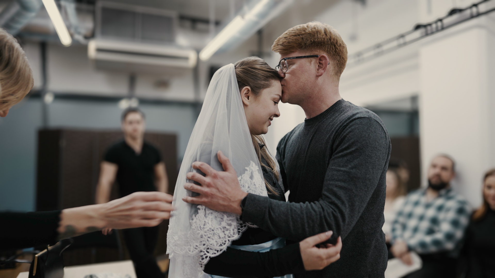 Intimate moment between performers in rehearsal