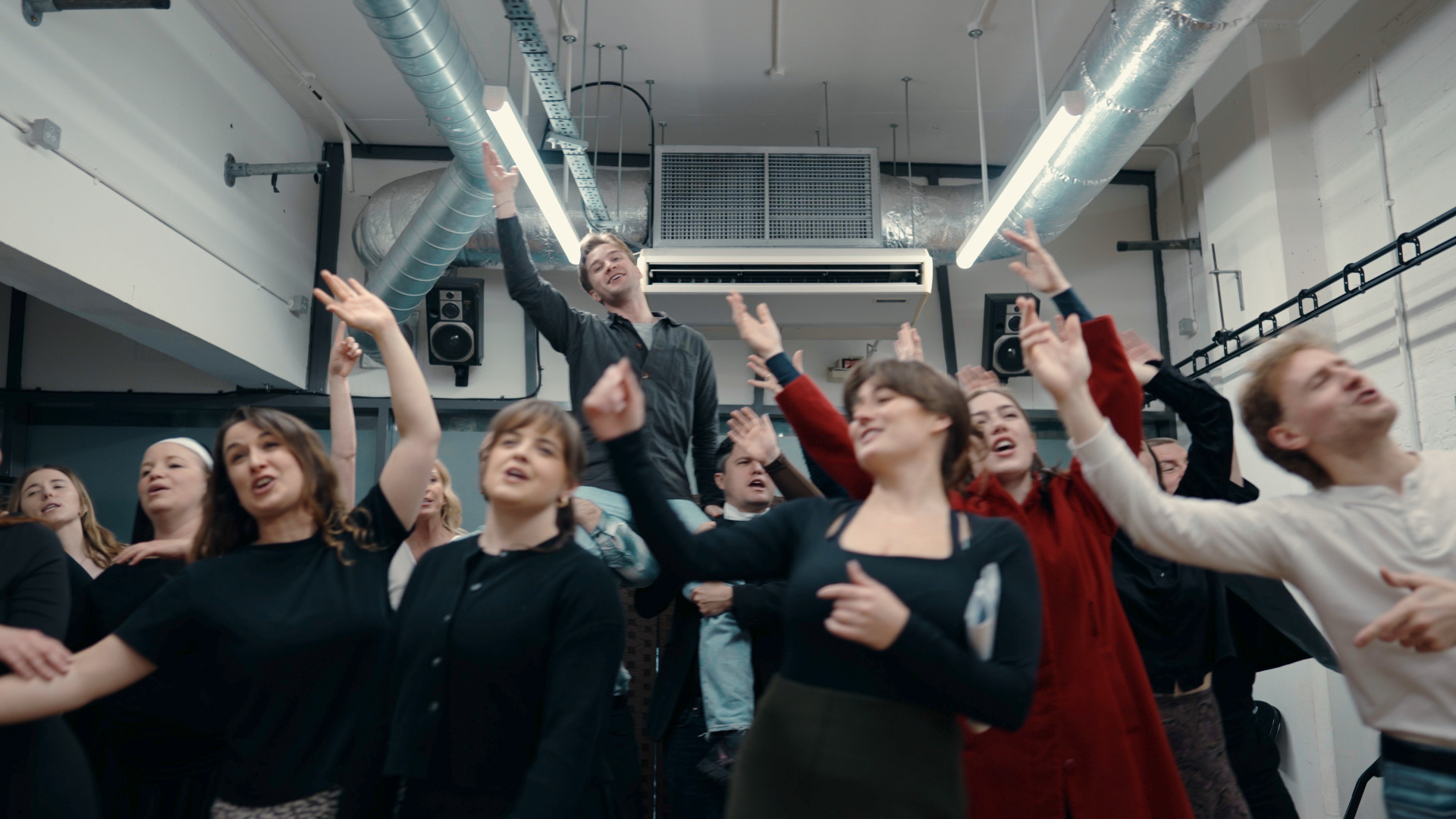 Cast members in an expressive ensemble number